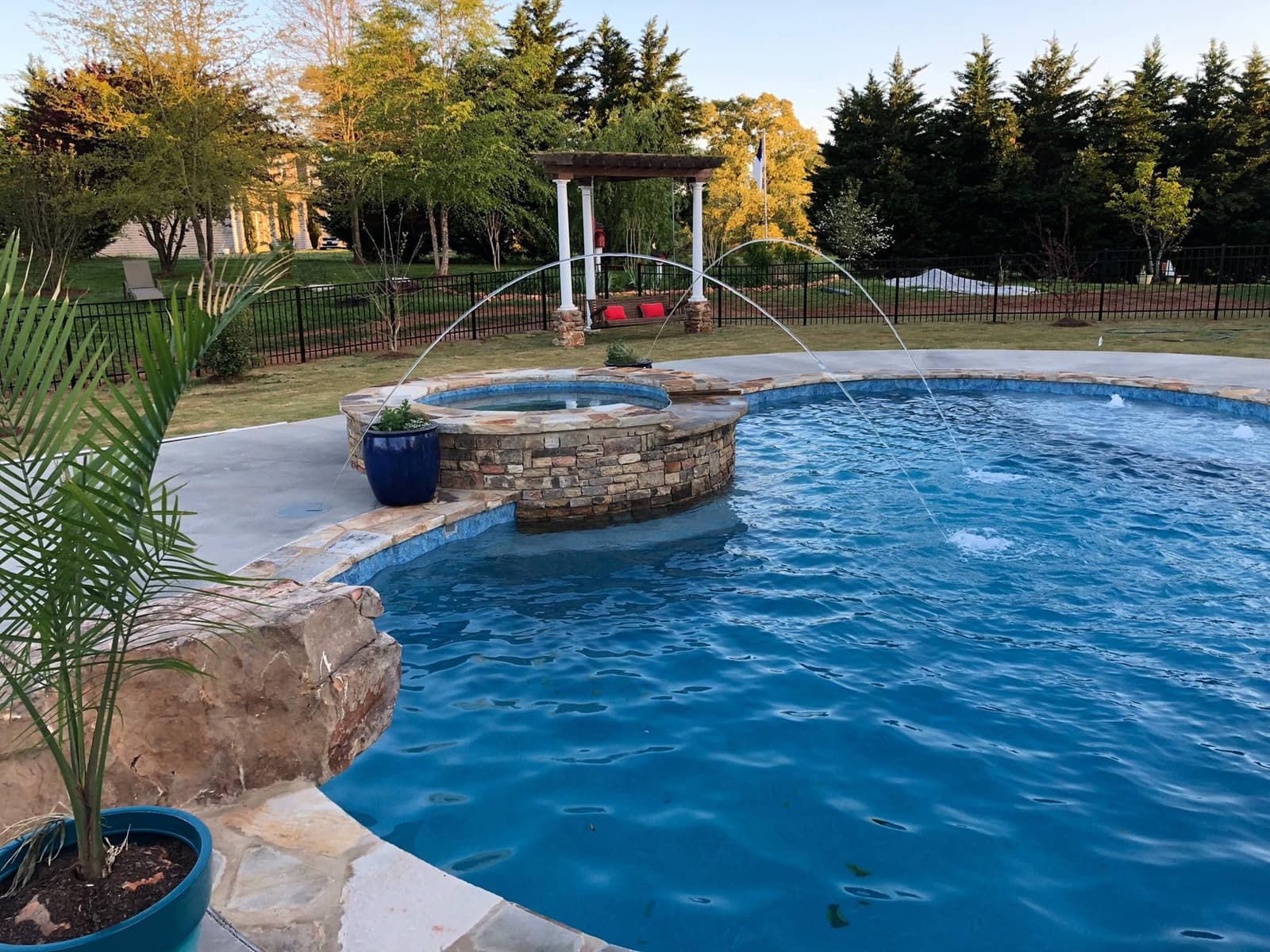 A custom gunite pool with spa and fountain arcs built by Whiten Pools